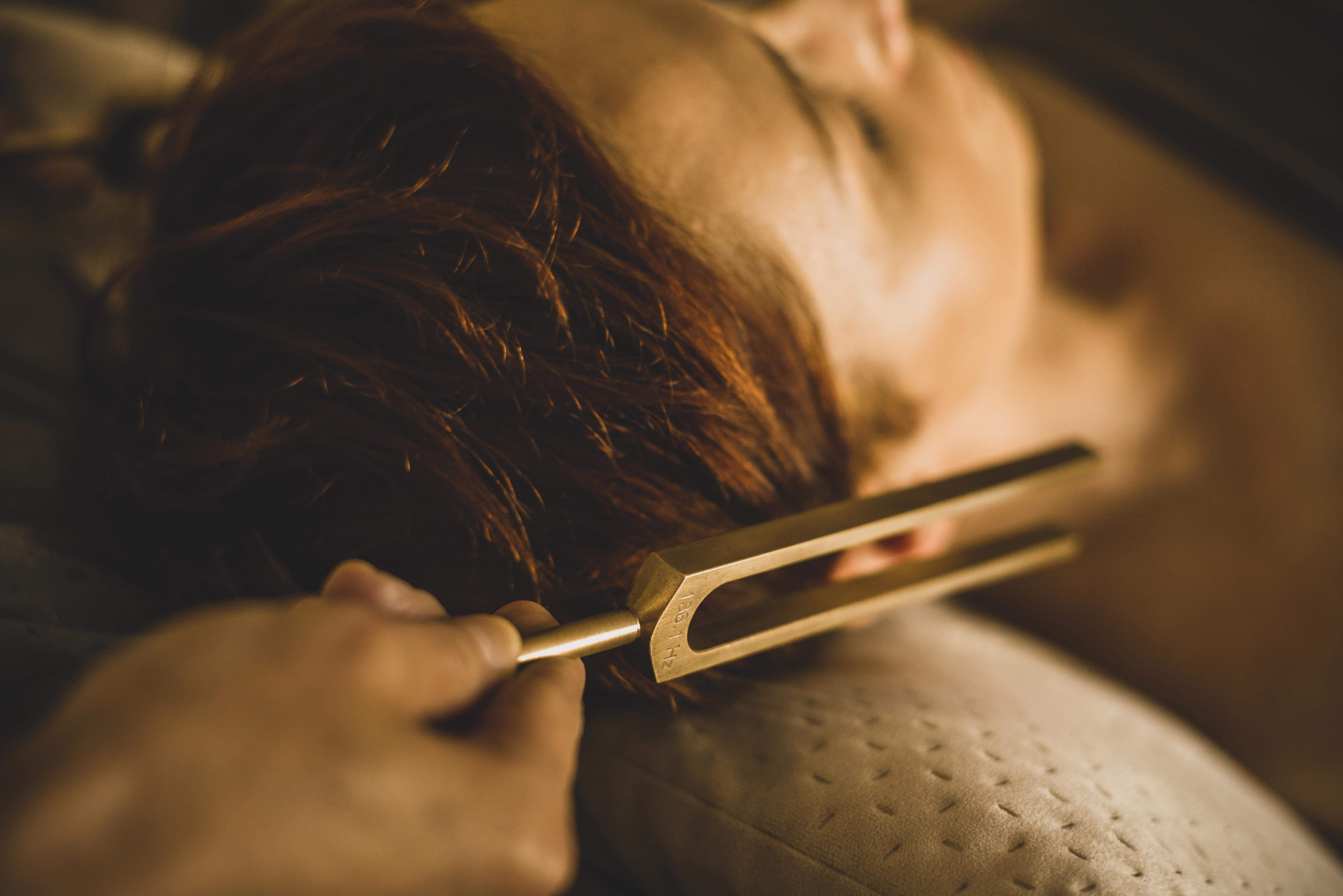 Kamerton mosiężny przy uchu kobiety zrelaksowanej